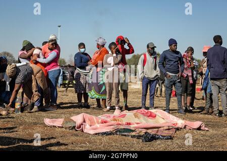 Johannesburg, Sudafrica. 14 luglio 2021. I familiari si lamentano per la morte delle vittime delle proteste a Johannesburg, Sudafrica, 14 luglio 2021. Un totale di 117 persone hanno perso la vita durante violente proteste che si svolgono da una settimana in Sudafrica, ha dichiarato giovedì il ministro agente della Presidenza Khumbudzo Ntshavheni mentre si è rivolto ai media in merito all'ultimo sviluppo delle proteste nel paese. PER ANDARE CON '117 uccisi in violente proteste in S. Africa' Credit: Yeshiel/Xinhua/Alamy Live News Foto Stock