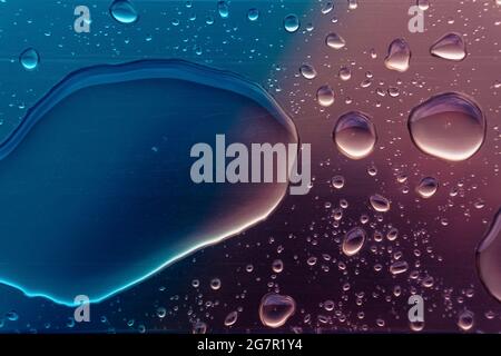 rendering 3d di gocce d'acqua su superficie viola blu. Foto Stock