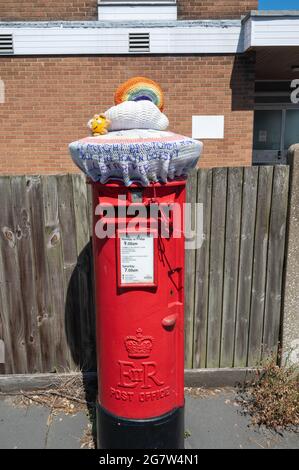 Caselle postali rosse Royal Mail con top in lana lavorato a mano in apprezzamento dei lavoratori chiave attraverso la pandemia del covid 19 Foto Stock