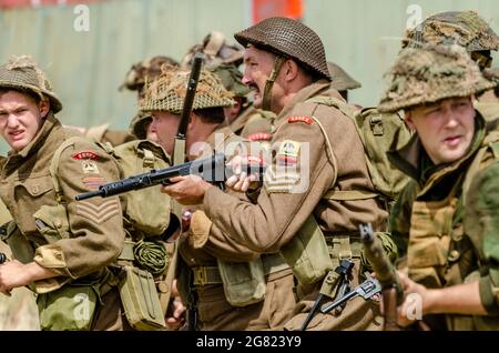 I re-enactor rievocano una battaglia della seconda guerra mondiale, con stemmi del reggimento Essex Foto Stock
