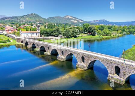 Una vista elevata del bellissimo ponte medievale che attraversa il fiume Lima, Portogallo, che risale al 1368 Foto Stock