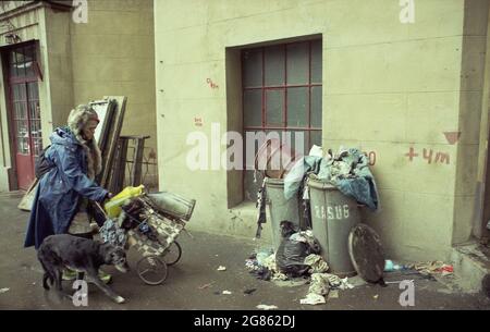Romania, 1993. Donna senza casa con il cane per strada. Foto Stock