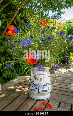 Bouquet nostalgico di campi con papaveri di mais (Papaver rhoeas) e cornflowers (Centaurea cyanus) in un vecchio vaso, Baviera, Germania, Europa Foto Stock