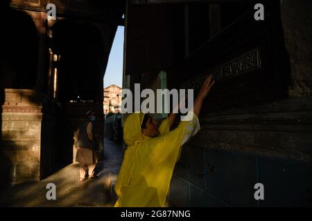 Srinagar, India. 17 luglio 2021. Una donna musulmana del Kashmiri prega fuori dal santuario di Sufi San Syed Ali Hamadani durante i suoi urs a Srinagar.centinaia di musulmani del Kashmiri si sono riuniti a Shrines per commemorare l'anniversario della morte di un famoso santo sufi, Mir Syed Ali Hamadani. Credit: SOPA Images Limited/Alamy Live News Foto Stock