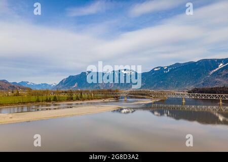 Fraser River vicino alla città di Agassiz con il ponte dell'autostrada Agassiz Rosedale e il monte Cheam sullo sfondo. Foto Stock