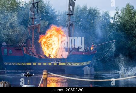 19 luglio 2021, Meclemburgo-Pomerania occidentale, Grevesmühlen: Una grande palla di fuoco sorge su una delle navi pirata durante la proiezione stampa dell'attuale produzione "UN regno prima del vento". The Pirate Open Air inizia su 23.07.2021 con la prima d'azione della stagione. Fino al 18.09.2021 sono previsti 50 spettacoli, ciascuno con 1,000 visitatori. Foto: Jens Büttner/dpa-Zentralbild/dpa Foto Stock