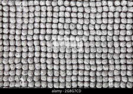 Fondo grigio, morbido tessuto del tappeto da bagno in cotone naturale Foto Stock