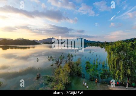 Huaying, Huaying, Cina. 21 luglio 2021. Il 20 luglio 2021, il lago Huaying Mountain Tianchi nella provincia di Sichuan, che ha subito un trattamento idrico ambientale ed è entrato nella stagione umida, sotto il sole tramontante e nuvole colorate, presenta lo splendido scenario dei Tianchi come specchio del cielo. (Credit Image: © SIPA Asia via ZUMA Press Wire) Foto Stock