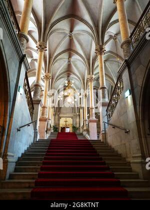 Wien, Aufgang am roten Teppich im Wiener Rathaus mit Säulen und Spitzbogengewölbe Foto Stock
