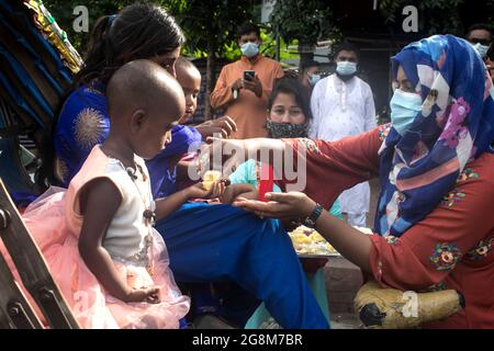 Dhaka, Bangladesh. 21 luglio 2021. Nafisa Anjum Khan, 'Ekjon Bangladesh' distribuisce cibo gratuito donato da Tanbir Hasan Shaikat e dal suo team durante l'Eid al-Adha. Credit: SOPA Images Limited/Alamy Live News Foto Stock