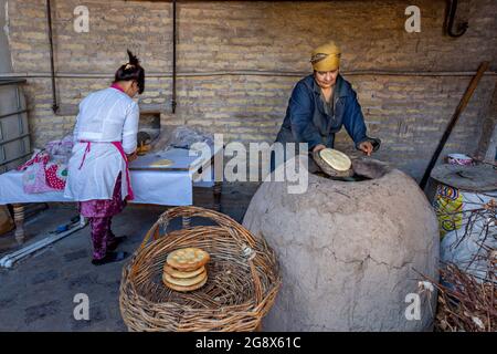 Donne uzbeche fanno pane tandoori a Khiva, Uzbekistan. Foto Stock