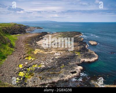 Piattaforma di taglio delle onde - rocce costiere erose dall'azione delle onde - vicino a Portrush sulla costa di Antrim Causeway nell'Irlanda del Nord, Regno Unito. Preso su un sole Foto Stock