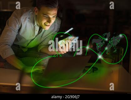 Uomo d'affari che utilizza tecnologie wireless circondate da una rete di computer Foto Stock