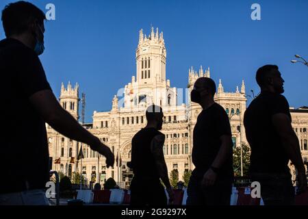 Madrid, Spagna. 23 luglio 2021. La gente attraversa l'attraversamento pedonale e dietro la facciata del Palacio de Cibeles situato sul Paseo del Prado a Madrid. Domenica 25 luglio 2021, il Paseo del Prado e il Parco Buen Retiro a Madrid sono molto probabilmente entrati nella lista del Patrimonio Mondiale dell'UNESCO. La superficie è di 190 ettari di estensione, dove sono inclusi 21 beni di interesse culturale, come un'abbondanza di istituzioni e monumenti famosi. Credit: SOPA Images Limited/Alamy Live News Foto Stock