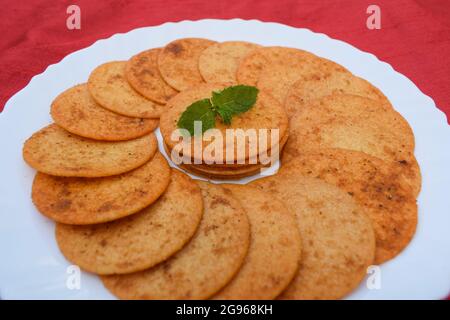 Cialde di patate sundried, deliziose e speziate. Rosso fresco spruzzato piccante sole essiccato senza frittura mungente tè tempo uno spuntino indiano Foto Stock