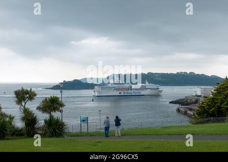 Una nave Brittany Ferries si dirige verso la bretone ormeggio a Plymouth guardata da Hoe Park da due persone Foto Stock