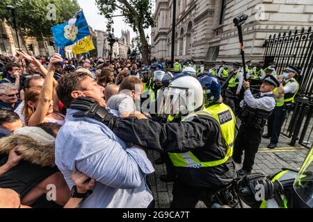 Londra, Regno Unito. 24 luglio 2021. I poliziotti trattengono i manifestanti durante la dimostrazione. I manifestanti si riuniscono nel centro di Londra per dimostrare la loro costernazione contro le restrizioni della covid, i passaporti dei vaccini e i test obbligatori. Credit: SOPA Images Limited/Alamy Live News Foto Stock