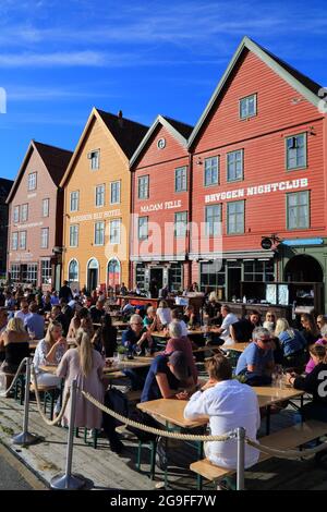 BERGEN, NORVEGIA - 23 LUGLIO 2020: La gente visita il caffè del marciapiede nel distretto di Bryggen di Bergen, Norvegia. È un sito patrimonio dell'umanità dell'UNESCO. Foto Stock