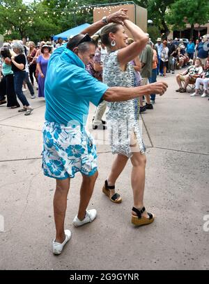 Ballerini di tutte le età riempiono la storica piazza di Santa Fe, New Mexico, durante un concerto estivo di musica dal vivo gratuita. Foto Stock