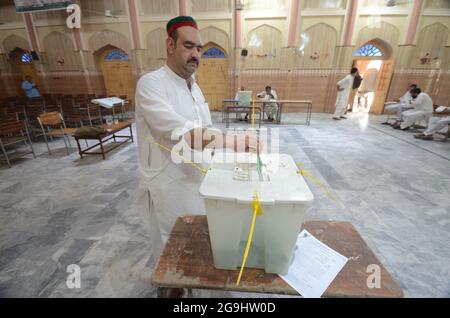 Peshawar, Pakistan. 25 luglio 2021. Un uomo che ha gettato lo scrutinio per le elezioni di Azad Kashmir 2021. Le persone sono in coda per esprimere il proprio voto. Credit: Sipa USA/Alamy Live News Foto Stock