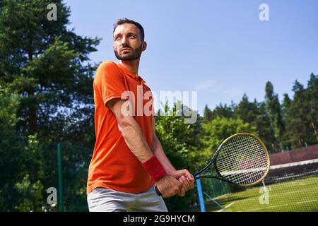 Il giocatore di tennis maschile si prepara a ricevere un servizio Foto Stock