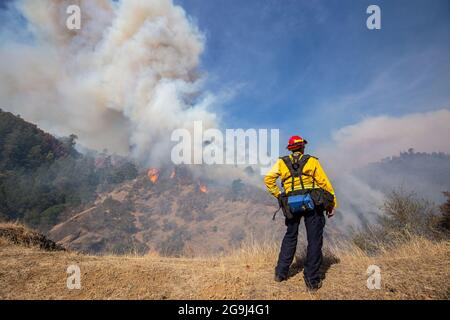 Un vigile del fuoco della California guarda come un fuoco spot cresce più grande sul fuoco di Kincade nella contea di Sonoma, California 24 ottobre 2019. Foto Stock