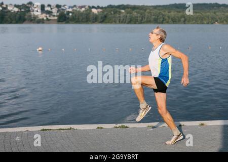 l'uomo anziano è impegnato a correre nell'aria fresca Foto Stock
