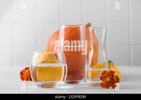 Autunno ancora vita di zucche distorte attraverso l'acqua in bicchieri. Il concetto di Ringraziamento o Halloween. Umore autunnale Foto Stock