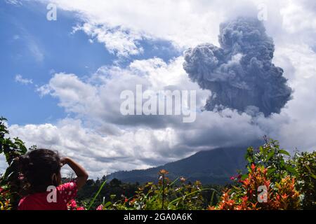 (210728) -- SUMATRA DEL NORD, 28 luglio 2021 (Xinhua) -- Foto scattata il 28 luglio 2021 mostra il Monte Sinabung che sputa materiali vulcanici e fumo come visto da Tiga Pancur a Karo, Sumatra del Nord, Indonesia. (Foto di Sarianto Sembiring/Xinhua) Foto Stock