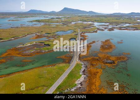 Vista aerea dal drone delle strade di Benbecula che attraversano gli estuari e si uniscono piccole isole attraverso Benbecula nelle Ebridi esterne, Scozia, Regno Unito Foto Stock