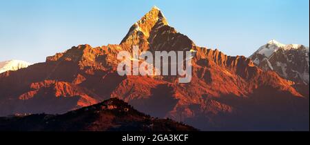 Vista del tramonto di colore rosso del monte Machhapuchhare, zona di Annapurna, Nepal himalaya Foto Stock