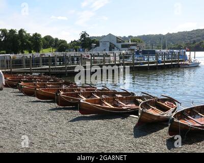 Barche a remi a noleggio si allineano sulla riva di Bowness-on-Windermere, una popolare destinazione turistica nel Distretto dei Laghi Inglesi. Foto Stock