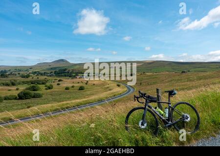 Vista in bicicletta di Pen-y-ghent da Stainforth Lane e Austwick Road in condizioni meteorologiche eccezionali con una bici da strada, Austwick, Yorkshire Dales National Park. REGNO UNITO L Foto Stock