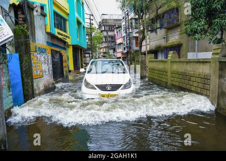 Kolkata, India. 30 luglio 2021. Un'auto ha visto sbattere attraverso una strada loggata durante il periodo successivo. Kolkata ha ricevuto il più pesante downpour della stagione causato da un sistema di bassa pressione su Bangladesh e Bengala Occidentale. (Foto di Avijit Ghosh/SOPA Images/Sipa USA) Credit: Sipa USA/Alamy Live News Foto Stock