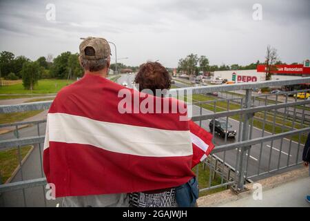 Riga, Lettonia. 30 luglio 2021. I tifosi aspettano sul ponte, mentre i 3 x 3 uomini di basket medaglia d'oro dei Giochi Olimpici di Tokyo passano dall'aeroporto internazionale di riga. Riga, Lettonia, 30 luglio 2021. Credit: Edijs Palens/Xinhua/Alamy Live News Foto Stock