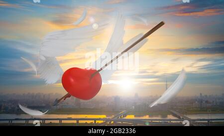 Rendering 3D di un cuore rosso con Angel Wings Shot in aria con le piume frantumate Foto Stock