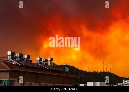 Fuoco di foresta in Turchia di Manavgat, fumi di fuoco, fumo in città, fiamme si innalzano al cielo, drammatica Alba nel fumo. Foto Stock