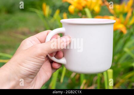 Mockup mug con bokeh verde natura. Foto Stock