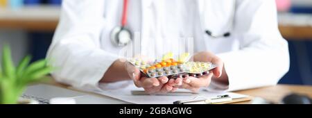 Il medico femminile sta tenendo vari farmaci nelle sue mani Foto Stock