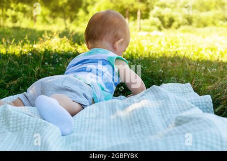 Ragazzo sdraiato su una coperta d'erba. Picnic. Foto Stock