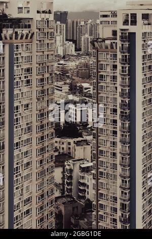 Immagine verticale di due alti edifici e altri piccoli sullo sfondo Foto Stock