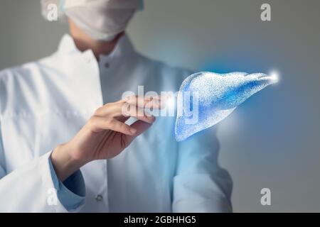 Il medico femminile tocca il fegato virtuale in mano. Foto sfocata, organo umano lavorato a mano, evidenziato in blu come simbolo di guarigione. Assistenza sanitaria ospedaliera Foto Stock