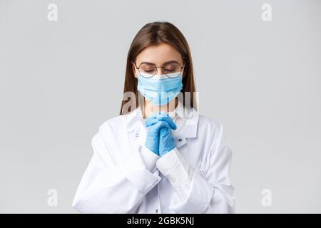 Covid-19, prevenzione di virus, salute, operatori sanitari e concetto di quarantena. Medico speranzoso in scrub e maschera medica, protettivo personale Foto Stock