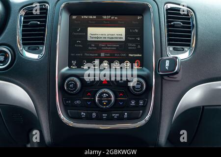 Ukraine, Odessa July 8 - 2021: Dodge Durango - car interior with multimedia display with russian menu. View from inside a car. Foto Stock