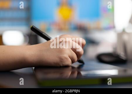 Primo piano di un fotografo professionista che ritoccia la mano modificando la foto del cliente utilizzando il computer con due display e penna stilo. Editor grafico ritocco di immagini disegnate su tavoletta grafica in studio Foto Stock