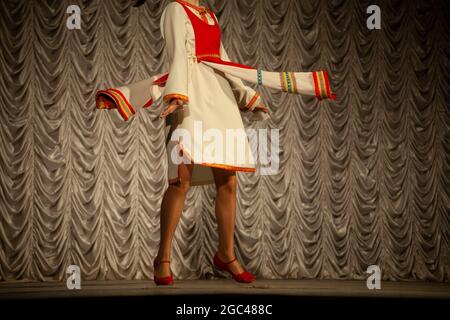 Una ragazza in costume popolare in Russia. Prestazioni sul palco. Lezione coreografica. La ragazza sta ballando in una lunga sventata. Foto Stock