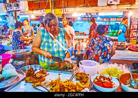 LAMPANG, THAILANDIA - 8 MAGGIO 2019: Il venditore del mercato Ratsada taglia il maiale bollito, l'8 maggio a Lampang Foto Stock