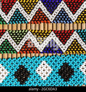 Braccialetti tribali africani dai colori vivaci. Closeup di intricate perline di lavoro per la vendita in un mercato di strada in Sud Africa. Foto Stock