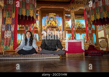 coppia meditante isolato all'interno del monastero buddista al mattino da basso angolo immagine è presa al monastero dirang arunachal pradesh india. Foto Stock