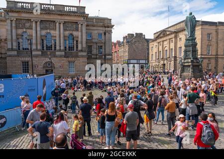 Edimburgo, Scozia, Regno Unito. 8 agosto 2021. Nel pomeriggio soleggiato della domenica il Royal Mile era pieno di visitatori alla ricerca del limitato intrattenimento di strada offerto durante il tanto scalato Edinburgh Fringe Festival di quest'anno. Sono previste due fasi per gli artisti che si sono dimostrati popolari durante tutta la giornata. PIC; la folla guarda l'artista in Piazza del Parlamento di fronte alla Cattedrale di San Giles. . Iain Masterton/Alamy Notizie dal vivo. Foto Stock